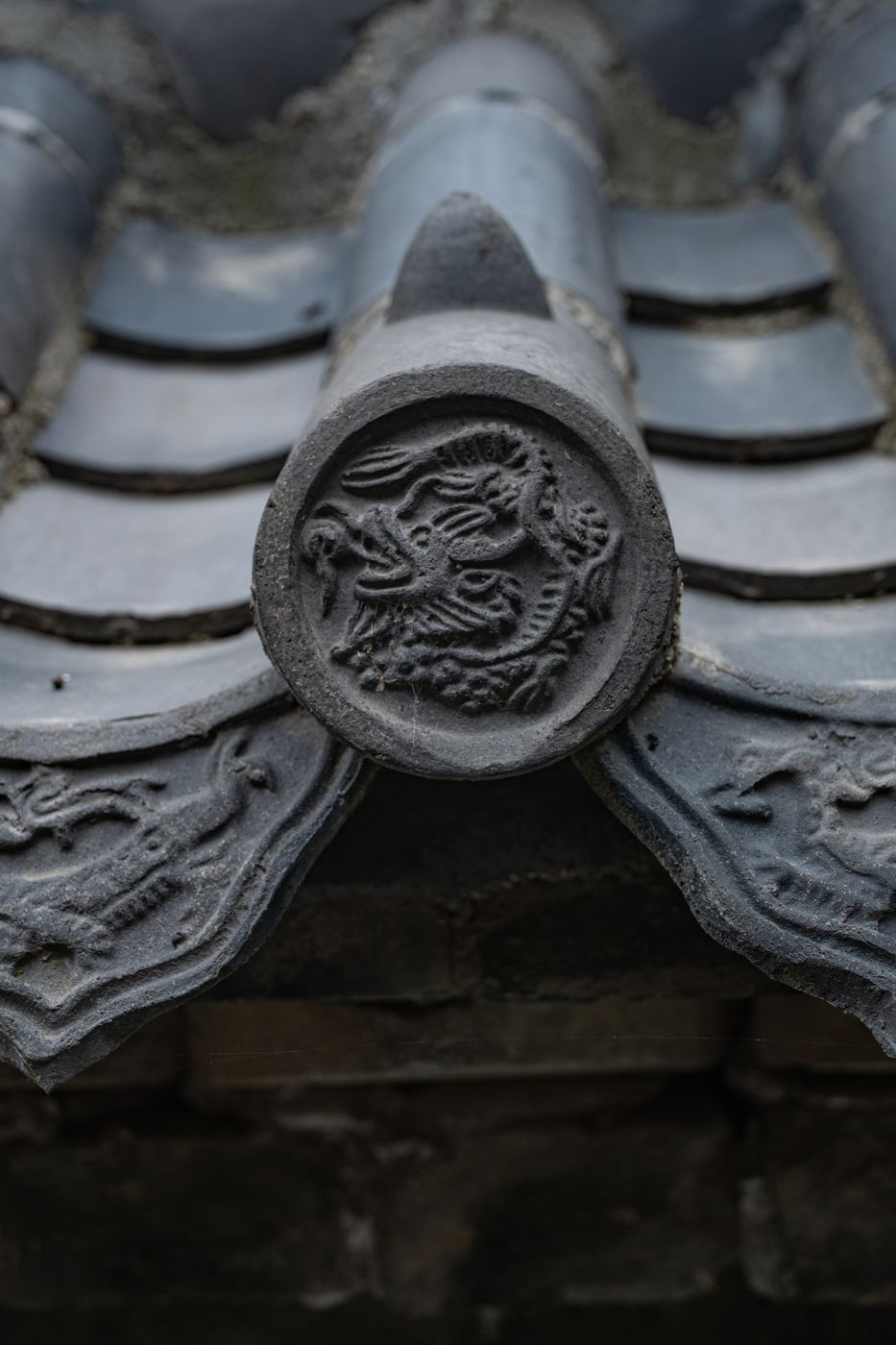 Dragon-relief roof tile photographed up close