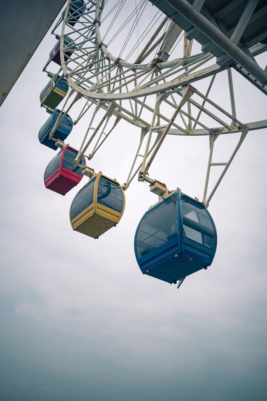 Ferris wheel gondolas against an overcast sky